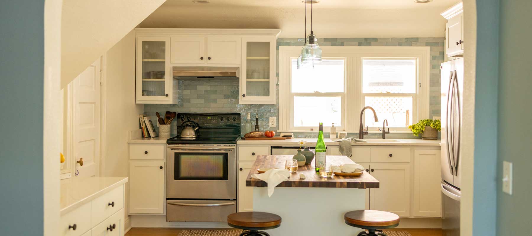 Remodeled kitchen with new flooring, paint, cabinetry
