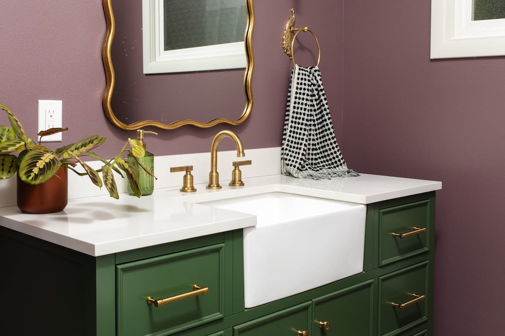 Bold New Orleans inspired colors adorn this remodeled bathroom